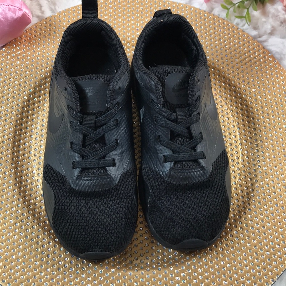 Nike all black shoes. Purchased and were too small .